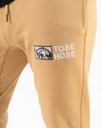 Tobe Hose Studio Herren-Jogginghose in Baum-Beige mit gesticktem Hyänen-Logo und praktischem Kordelzug