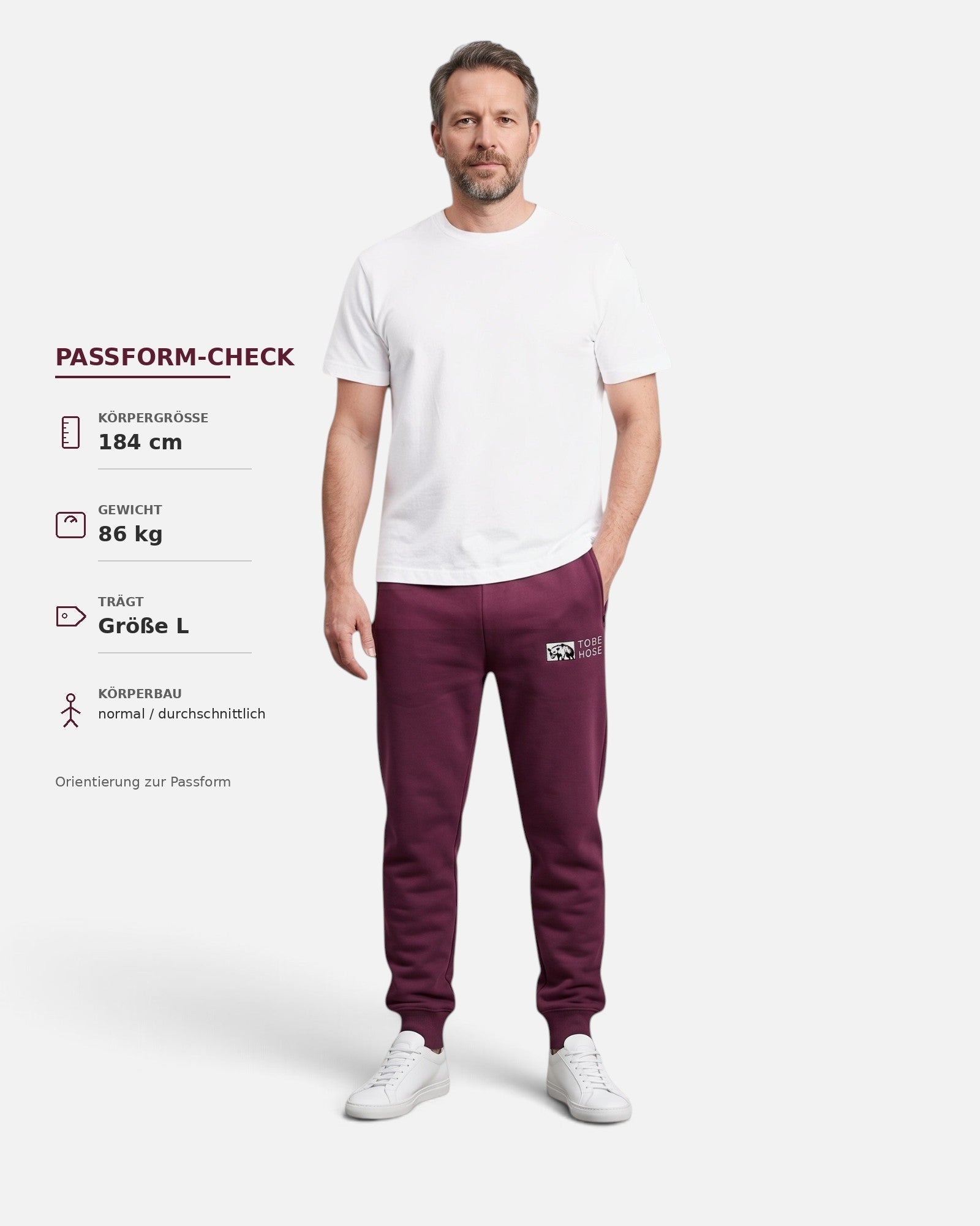 Tobe Hose Studio Herrenhose in Pflaume mit Bündchen, Reißverschlusstaschen und Hyänen-Logo, getragen von einem Model
