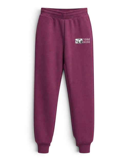 Tobe Hose Studio Herren-Jogginghose in Pflaume mit elastischem Bund, Reißverschlusstaschen und Hyänen-Logo-Stickerei.
