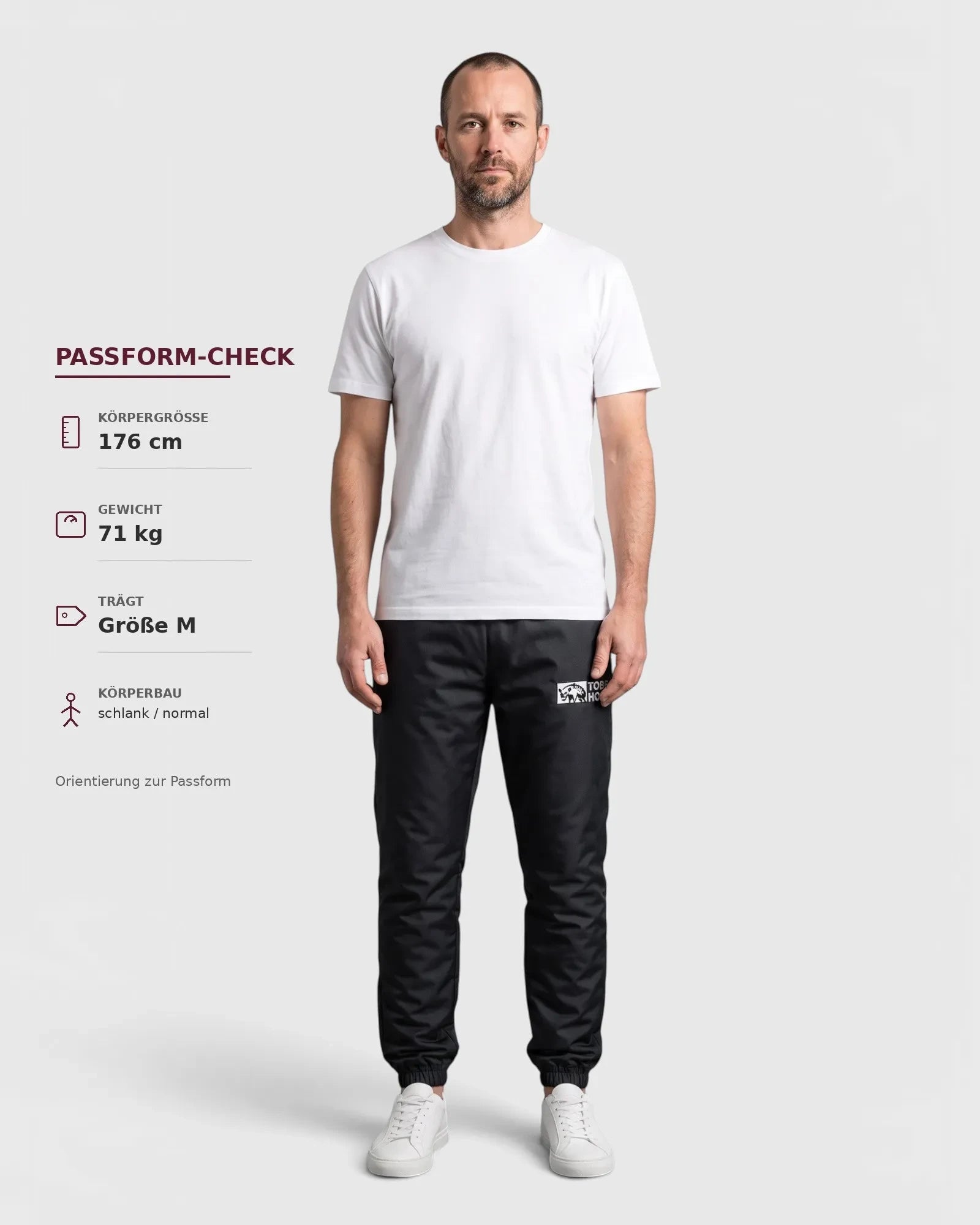 Tobe Hose Studio Luft Herrenhose in Schwarz aus robustem Nylon mit gesticktem Hyänen-Logo und Reißverschlusstaschen